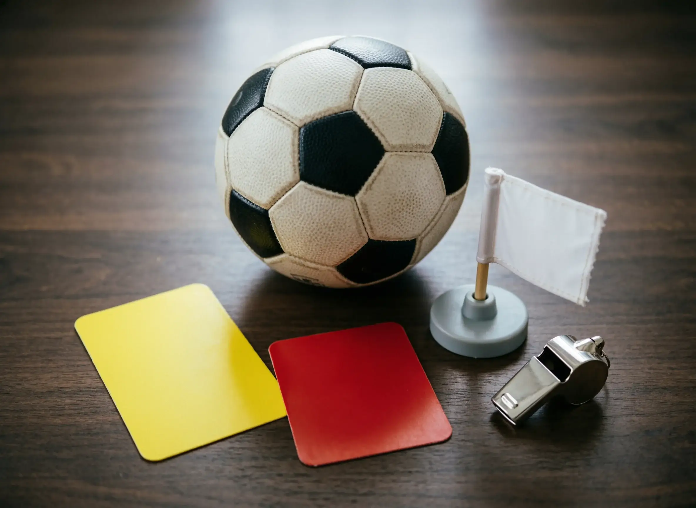 Composizione con pallone da calcio, cartellino giallo, bandierina del corner su un tavolo